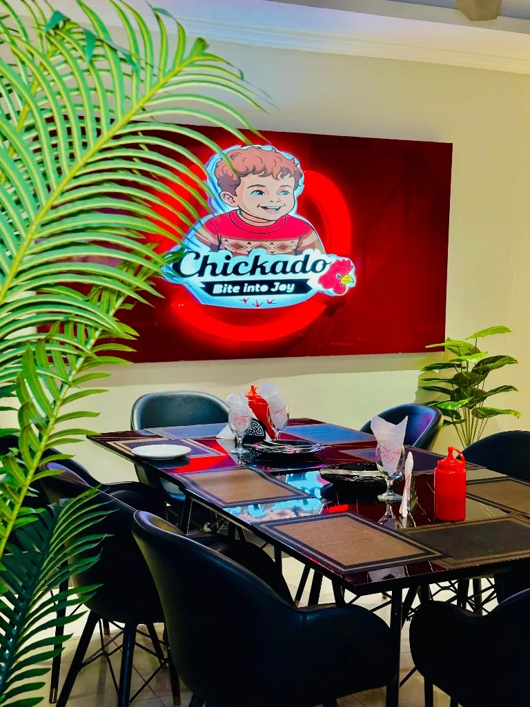 Chickado Flagship Restaurant Dining Area & Bite Into Joy Sign